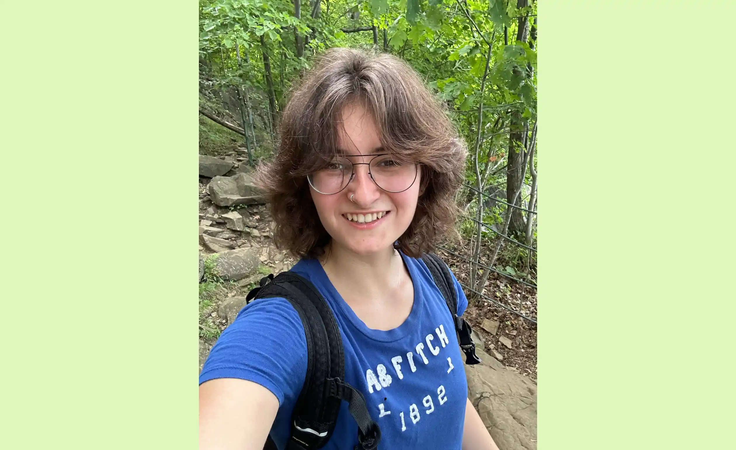 A selfie of Ruby Friedman hiking in the woods.